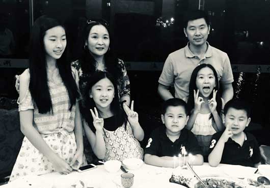The Kuang Family is the center of Dawn Kitchen & Bath Products, Inc.’s heart. Pictured with their family are Vice President of Operations Jenny Ma Kuang (standing second from left) and Founder and President Herman Kuang (standing third from left).